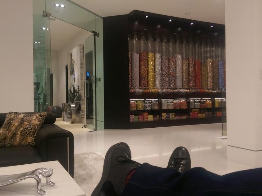 he-seems-to-be-enjoying-life-in-his-new-home-shortly-after-news-of-the-blockbuster-purchase-broke-he-tweeted-this-photo-of-him-lounging-by-an-enormous-wall-of-candy.jpg