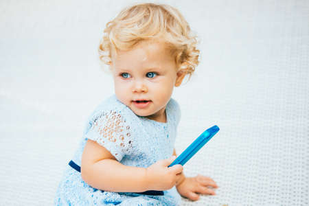50842427-portrait-of-cute-blonde-baby-girl-with-smartphone.jpg